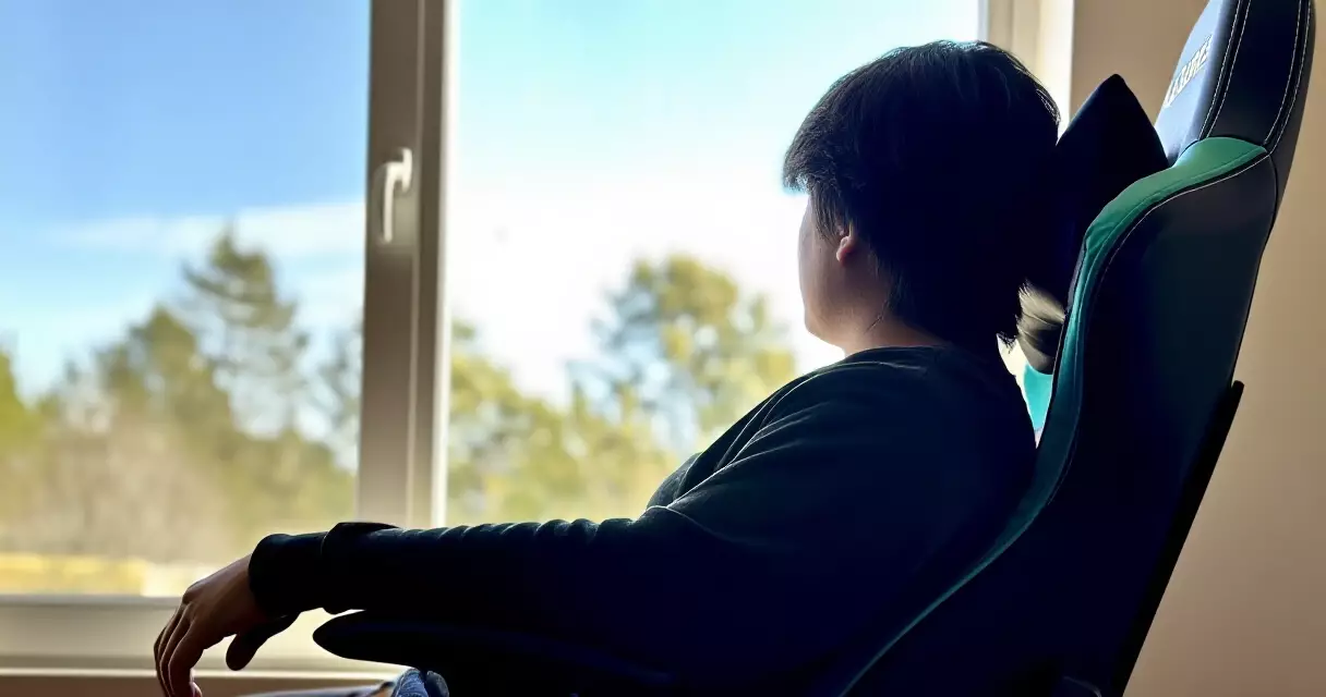 Gamer looking away from screen toward a distant window during a 20-20-20 eye break
