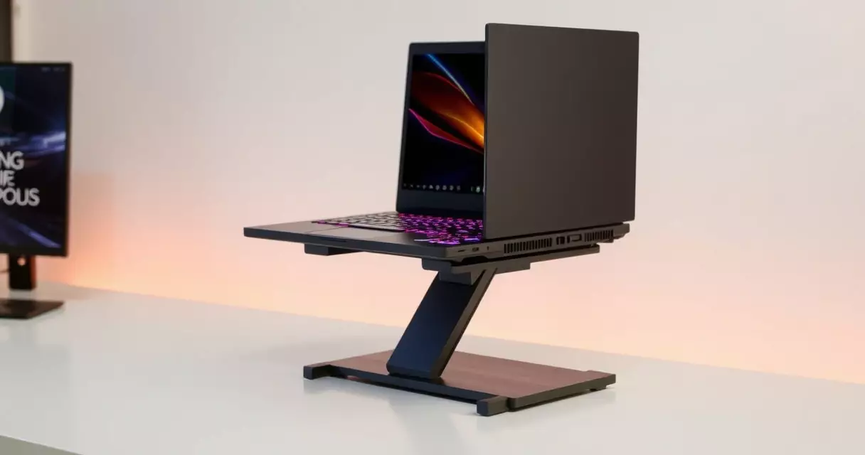 Gaming laptop elevated on a cooling stand showing rear exhaust vents