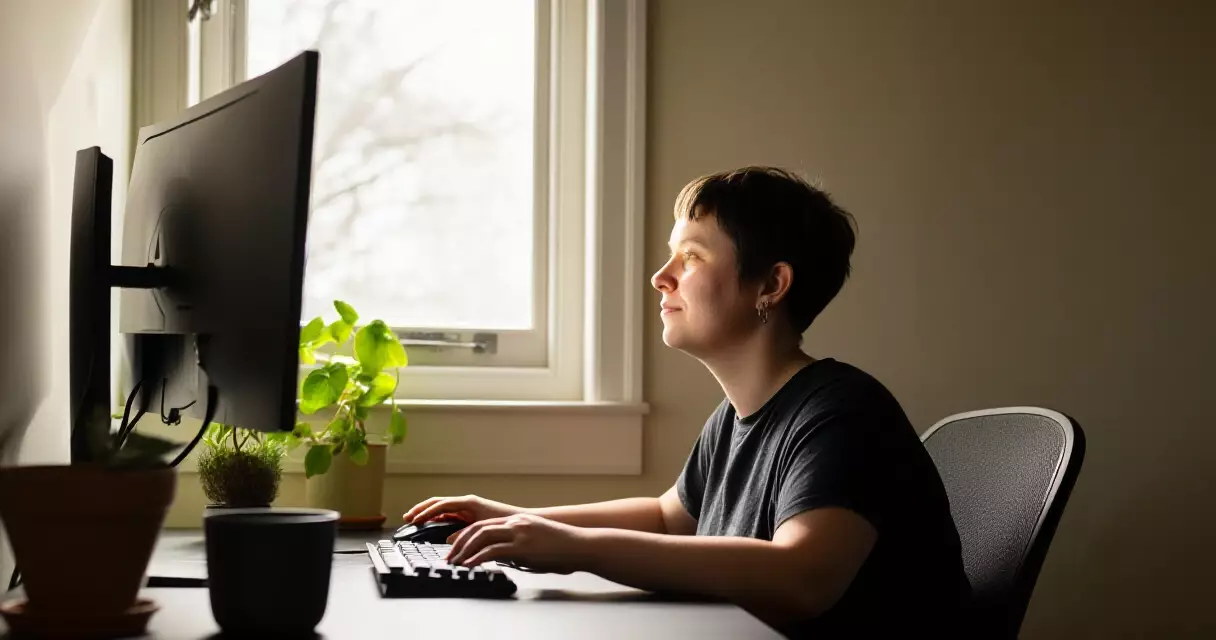 Gamer practicing focused gaming at a well-lit desk with natural light