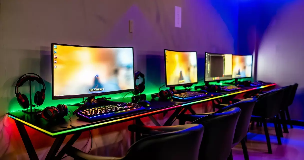 Gaming cafe interior with PC stations and LED lighting in Southeast Asia
