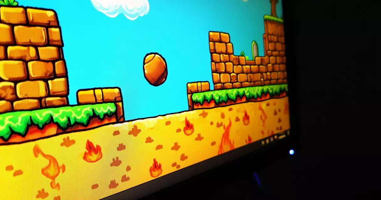 Gaming monitor showing vivid hand-drawn 2D indie platformer scenery