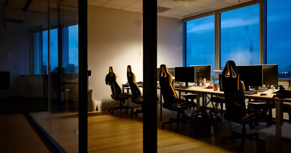 Empty game studio desks in an office during a company restructuring