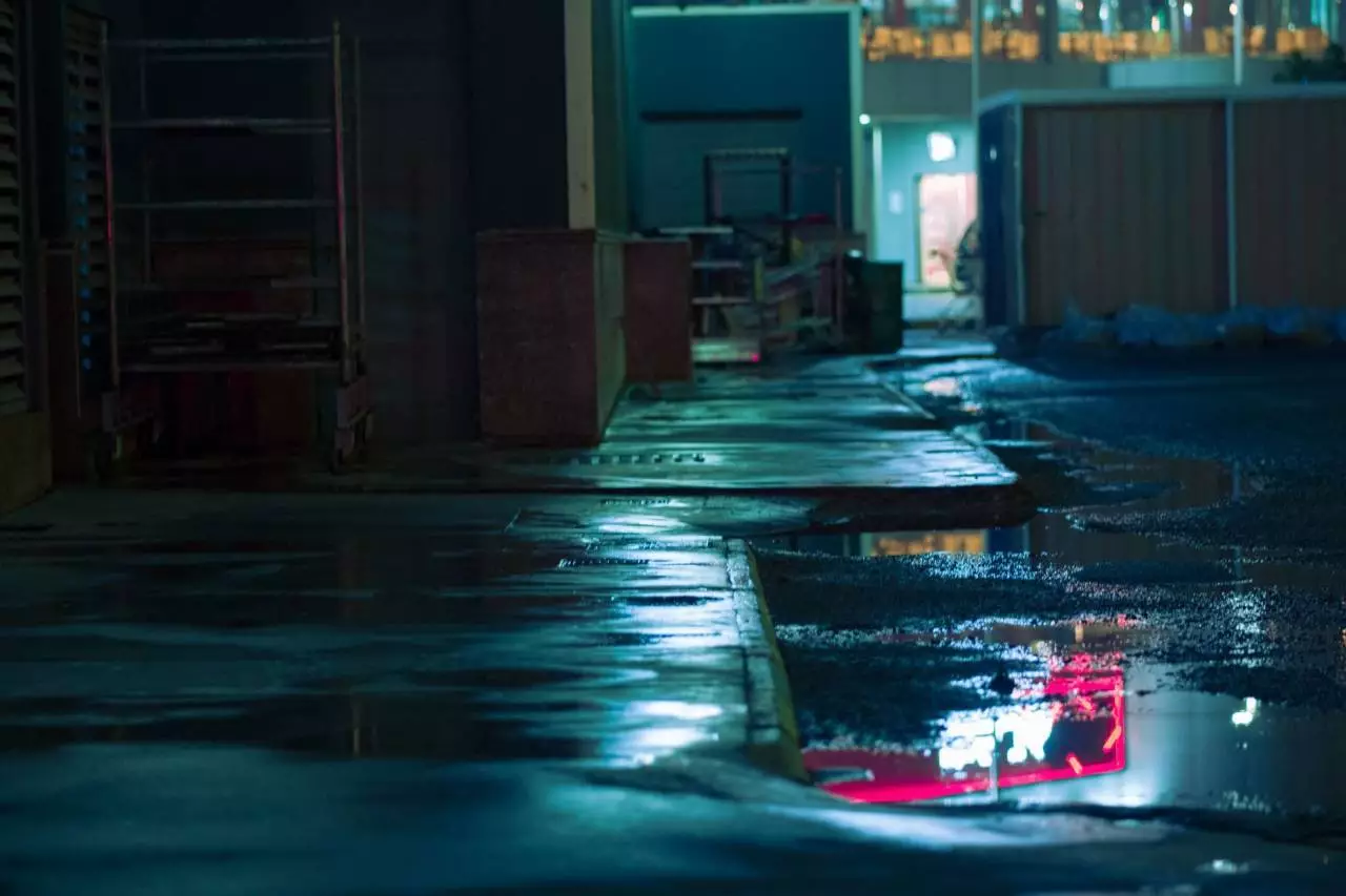 Cinematic night street with wet pavement and neon reflections representing the GTA 6 open world city environment and Take-Two Interactive release update