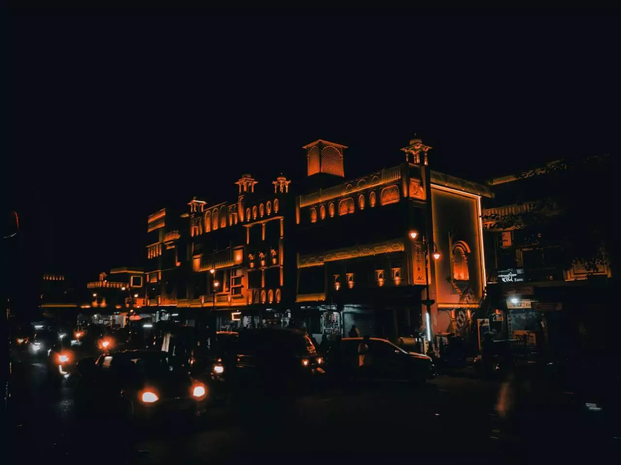 Orange-lit urban cityscape with bustling street traffic representing the GTA 6 open world city and Rockstar Games launch timeline in 2026